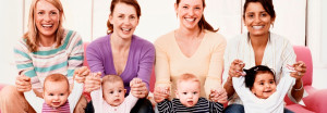 Portrait of Four Young Mothers with Their Babies banner